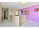 Hallway with access to various rooms, neutral carpet, and a lavender accent wall at 8630 Aylesworth Dr, Camby, IN 46113