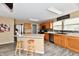 Functional kitchen with stainless steel appliances, wood cabinets, a kitchen island, and gray backsplash at 8630 Aylesworth Dr, Camby, IN 46113