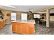 Spacious kitchen opening up to the living room, showcasing an island with seating and open floor plan at 8630 Aylesworth Dr, Camby, IN 46113