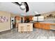 Open kitchen design with a kitchen island, stainless steel appliances, and natural wood cabinets at 8630 Aylesworth Dr, Camby, IN 46113