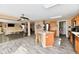 Open concept kitchen flowing into the living room, featuring an island with seating and stainless appliances at 8630 Aylesworth Dr, Camby, IN 46113