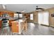 Bright kitchen featuring wood cabinets, a kitchen island with seating, and sliding glass doors to the outside at 8630 Aylesworth Dr, Camby, IN 46113
