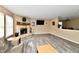Spacious living room features a fireplace, wood flooring, and a view of the dining room at 8630 Aylesworth Dr, Camby, IN 46113