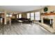 Bright, open living space with wood flooring and views into the dining room and kitchen at 8630 Aylesworth Dr, Camby, IN 46113