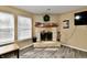 Bright living room features a fireplace, natural light, and wood-style flooring at 8630 Aylesworth Dr, Camby, IN 46113
