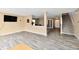 Open floor plan living room with wood floors, staircase, and views into the dining room at 8630 Aylesworth Dr, Camby, IN 46113