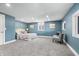 Bedroom featuring calming blue walls, plush gray carpeting, and bright recessed lighting at 914 Chase St, Anderson, IN 46016