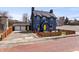 Inviting blue two-story home with yellow door and brick street at 914 Chase St, Anderson, IN 46016