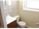 Cozy bathroom featuring a white vanity, toilet and large window, perfect for natural lighting and ventilation at 9238 Celtic Ct, Indianapolis, IN 46235