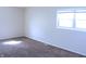 This bedroom features plush carpet, light-filled window, and neutral walls at 9238 Celtic Ct, Indianapolis, IN 46235