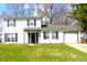 Charming two-story home with a well-maintained lawn and classic curb appeal enhanced by dark shutters and door at 9238 Celtic Ct, Indianapolis, IN 46235