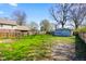 Spacious backyard featuring a wooden deck, detached garage, and a mix of gravel and grassy areas at 93 Walnut St, Indianapolis, IN 46227