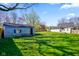 View of a large, lush backyard with a weathered shed and mature trees, offering a private outdoor space at 93 Walnut St, Indianapolis, IN 46227