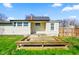 Charming backyard with a small deck in front of a home with yellow siding at 93 Walnut St, Indianapolis, IN 46227