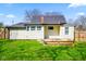 Backyard featuring a small deck and view of the house's yellow exterior siding at 93 Walnut St, Indianapolis, IN 46227
