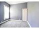 A cozy bedroom features soft gray carpet and a window offering natural light at 93 Walnut St, Indianapolis, IN 46227
