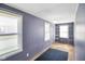 Bright bedroom with natural light, showcasing three windows and metal shelving at 93 Walnut St, Indianapolis, IN 46227