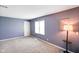 Carpeted bedroom featuring a window and vintage lighting in a simple setting at 93 Walnut St, Indianapolis, IN 46227