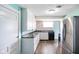 Charming kitchen with white cabinets, marble counters, and stainless steel refrigerator at 93 Walnut St, Indianapolis, IN 46227