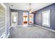 Living room with a ceiling fan, fresh paint, and views into the sun room at 93 Walnut St, Indianapolis, IN 46227