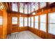 Cozy sun room with natural wood paneling, great light, and durable flooring at 93 Walnut St, Indianapolis, IN 46227