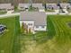 Aerial view of a well-maintained backyard featuring a deck, pergola, and lush green lawn at 9559 Summer Hollow Dr, Fishers, IN 46037