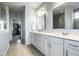 Elegant bathroom with double vanity, large mirrors, and walk-in closet, providing style and functionality at 9559 Summer Hollow Dr, Fishers, IN 46037