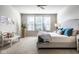 Inviting bedroom with neutral walls, large window, carpeted floor, bed with soft pillows, and bedside table at 9559 Summer Hollow Dr, Fishers, IN 46037