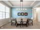 An elegant dining room with stylish light fixture and a light blue accent wall at 9559 Summer Hollow Dr, Fishers, IN 46037