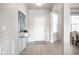 Bright foyer featuring hardwood floors, decorative molding, and an elegant glass console table at 9559 Summer Hollow Dr, Fishers, IN 46037