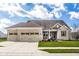Charming brick home with a well-manicured lawn, a spacious three-car garage, and a welcoming front porch at 9559 Summer Hollow Dr, Fishers, IN 46037