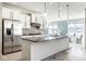 Eat-in kitchen features stainless steel appliances, island with bar, mosaic backsplash, and plenty of natural light at 9559 Summer Hollow Dr, Fishers, IN 46037