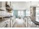 Bright kitchen features stainless steel appliances, mosaic backsplash, and dining space with plenty of natural light at 9559 Summer Hollow Dr, Fishers, IN 46037