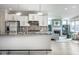 A modern kitchen opens to a bright living space with a fireplace, blending style and functionality at 9559 Summer Hollow Dr, Fishers, IN 46037