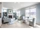 Inviting living room with a fireplace, built-in shelves, neutral color palette, and large windows for natural light at 9559 Summer Hollow Dr, Fishers, IN 46037
