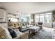 Open-concept living room features a cozy seating area, plush rug, and lots of natural light at 9559 Summer Hollow Dr, Fishers, IN 46037