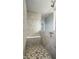 Modern shower area with tiled walls, mosaic tile floor, built-in bench, and sleek glass enclosure at 9559 Summer Hollow Dr, Fishers, IN 46037