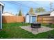 Backyard featuring a shed, fire pit with seating, and a well-maintained lawn at 1014 Shannon Ave, Indianapolis, IN 46201