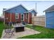 Spacious backyard with a fire pit, outdoor seating, brick exterior, and privacy fence at 1014 Shannon Ave, Indianapolis, IN 46201