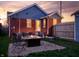 Backyard with a fire pit, outdoor seating, string lights, and well-maintained lawn at 1014 Shannon Ave, Indianapolis, IN 46201