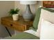 Bedroom decor with wooden nightstand, modern lamp and lush green indoor plant at 1014 Shannon Ave, Indianapolis, IN 46201