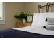 Cozy bedroom featuring a comfortable bed and stylish nightstand with plant and clock at 1014 Shannon Ave, Indianapolis, IN 46201