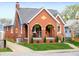 Charming brick home with arched porch and manicured lawn at 1014 Shannon Ave, Indianapolis, IN 46201