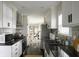 Spacious kitchen with modern appliances, dark countertops and sink, and dark wood floors at 1014 Shannon Ave, Indianapolis, IN 46201
