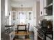 Bright kitchen with white cabinets, modern appliances, and dining area with hardwood floors and stainless steel sink at 1014 Shannon Ave, Indianapolis, IN 46201