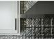 Close-up of kitchen backsplash showcasing stainless steel range hood and white cabinetry at 1014 Shannon Ave, Indianapolis, IN 46201