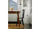 Dining table showing the window with blinds, hardwood floors, and built in shelving at 1014 Shannon Ave, Indianapolis, IN 46201