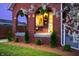 Inviting arched brick porch with stylish seating and verdant hanging plants at 1014 Shannon Ave, Indianapolis, IN 46201