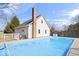 Backyard with a swimming pool covered by a blue tarp, with a brick chimney and fencing at 10333 E 211Th St, Noblesville, IN 46062