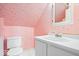 Compact bathroom featuring a pink patterned wallpaper, white sink, vanity and toilet at 10333 E 211Th St, Noblesville, IN 46062